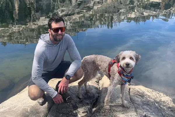 Ray Peart at the river with his dog.